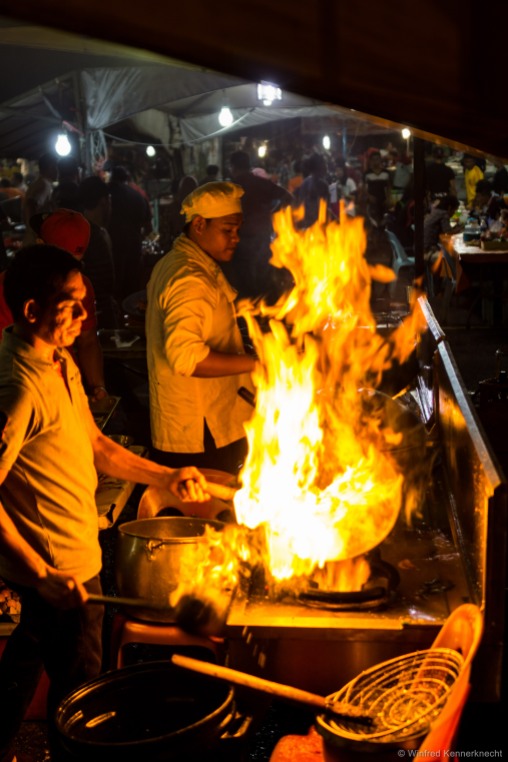 A chef mastering the art of flambéing in Kota Kinabalu, Malaysia.